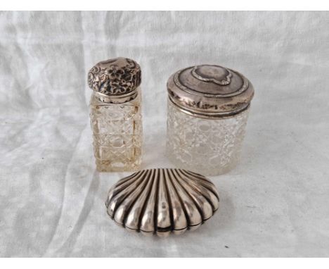 Two silver top jars with glass bodies and a shell shaped box