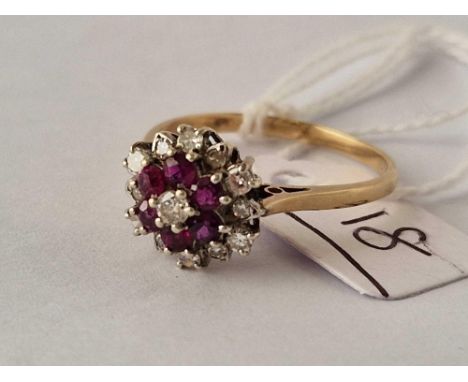 A diamond and ruby cluster ring set in gold size V