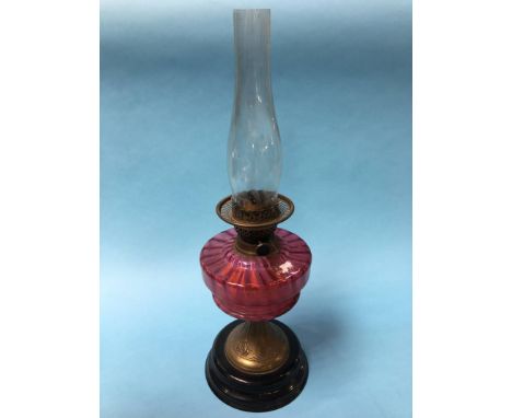 An oil lamp with cranberry reservoir