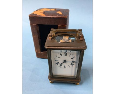 A small brass carriage clock and case