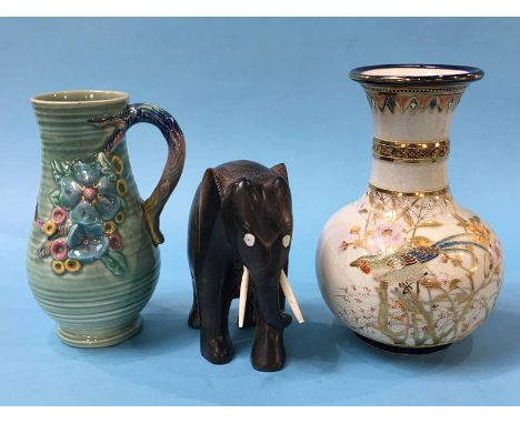 A Clarice Cliff water jug, a Satsuma vase and a carved elephant