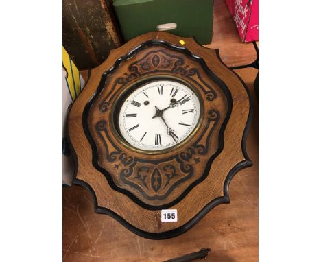 An oak cased wall clock