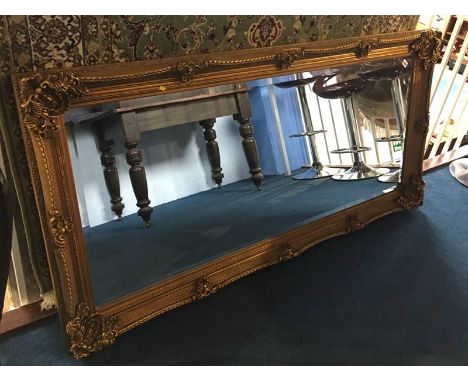 A large modern gilt rectangular mirror