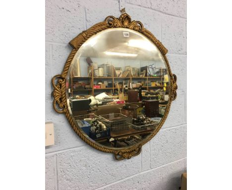 A gilt edged circular mirror