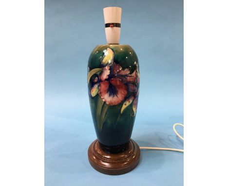 A Moorcroft table lamp on a mottled green ground, decorated with Iris's, 36cm height