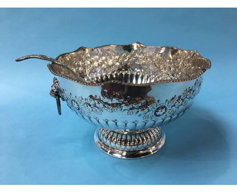 A large silver plated punch bowl and a serving ladle