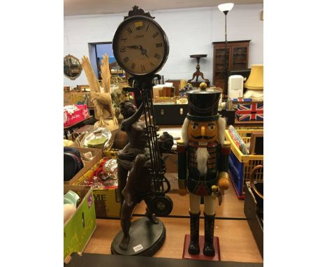 A Juliana Quartz clock and a wooden soldier figure