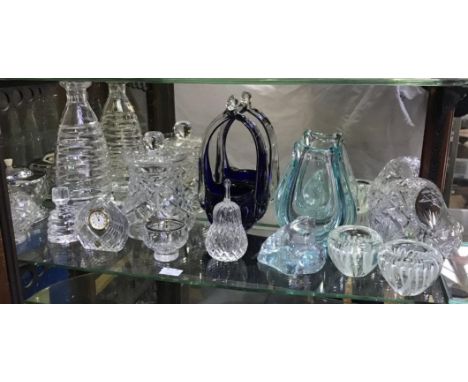 A shelf of assorted glass including a decanter and stopper of spiral design, together with a bohemian crystal clock, apple, f