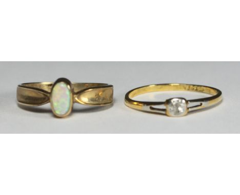 An 18ct gold ring set with a small solitaire diamond, gross weight approximately 1.5g, together with a 9ct gold opal ring, gr