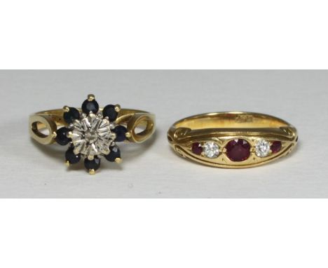 Two various 18ct gold rings, one centrally illusion set with a solitaire diamond surrounded by sapphire coloured stones, the 