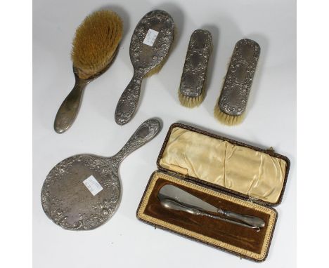 A five-piece silver backed brush and mirror set by Gorham Manufacturing Co. hallmarked Birmingham, 1911, (mirror AF) together
