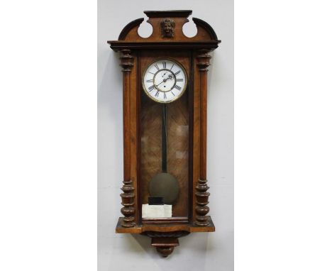 A walnut cased Vienna wall clock by Gustav Becker, white enamel dial, Roman numerals, gold chapter ring, shaped pediment with