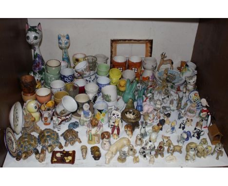 SECTION 7.  A large collection of novelty egg cups together with Wade whimsies, miniature Sylvac bunnies, Beatrix Potter's 'H