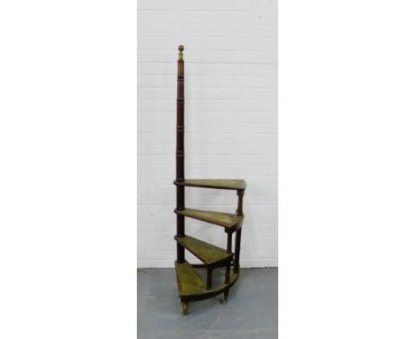 A set of mahogany library steps, on a turned support with brass finial, on brass caps and castors, 162cm high