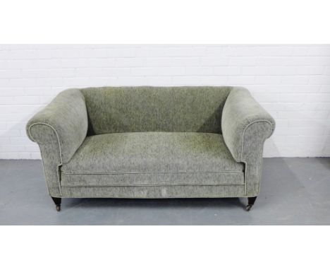 A contemporary  green two seater sofa, with square tapering feet and castors