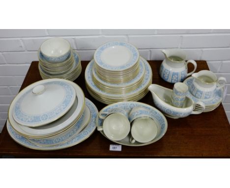 A Royal Doulton Hampton Court patterned dinner service comprising seven dinner plates, seven side plates, seven medium plates