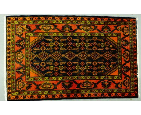 A Hamadan rug, the central panel with a row of six  lozenges within multiple flowerhead borders, 164 x 103cm