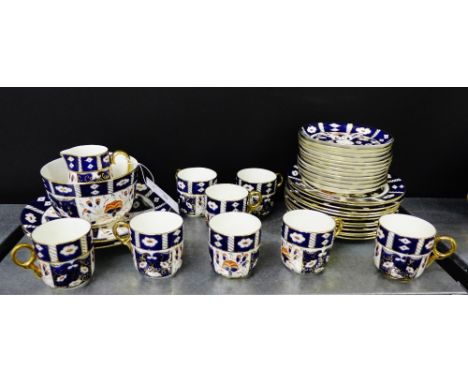 A Staffordshire Imari patterned tea set comprising twelve cups, twelve saucers, twelve side plates, two cake plates, a sugar 