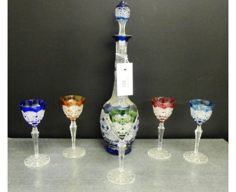 A cut crystal decanter set together with a set of five Harlequin coloured glasses, (6) 