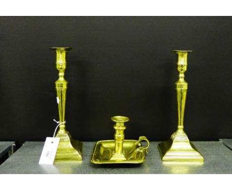 A pair of brass candlesticks and a brass chamber stick, (3) 