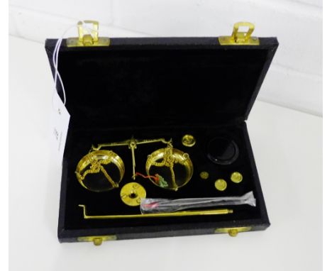 A cased set of scales, complete with its weights