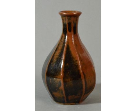 SHIGEYOSHI ICHINO (born 1942) for Leach Pottery; a stoneware cut-sided bottle vase, covered in khaki and tenmoku glaze, impre