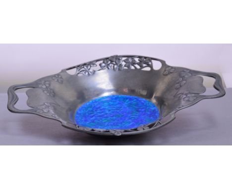 LIBERTY & CO; a polished pewter enamel decorated twin handled bowl, the pierced heart shaped handles flanked by pierced leaf 
