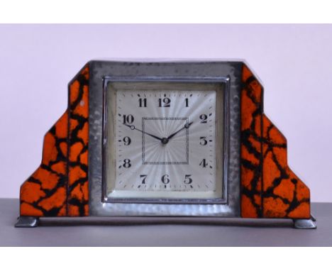 LIBERTY & CO; a Tudric pewter and unusual black and orange enamel decorated timepiece, the stepped shaped case centred with a