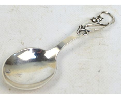 CARL M COHR; a Danish silver caddy spoon with pierced foliate decorated handle and rounded bowl, hallmarked for Cohr, Frederi