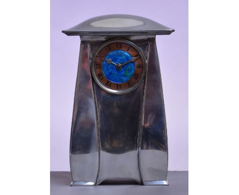 ARCHIBALD KNOX FOR LIBERTY & CO; a Tudric polished pewter mantel timepiece, the overhanging domed top above blue/green enamel
