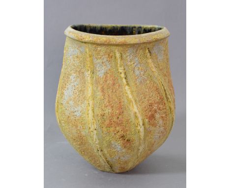CHRIS CARTER (born 1945); a stoneware axe-head form, textured surface covered in mottled yellow/brown glaze, impressed CCP ma