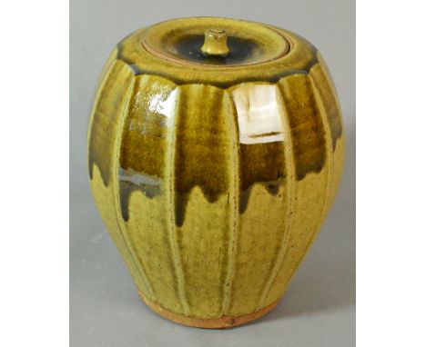 PHIL ROGERS (born 1951); a cut-sided stoneware jar covered in green ash glaze, impressed PR mark, height 22cm. (D) CONDITION 