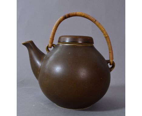 Arabia Pottery, Finland; a porcelain teapot with cane handle, pottery stamp, height 20cm (including handle). CONDITION REPORT