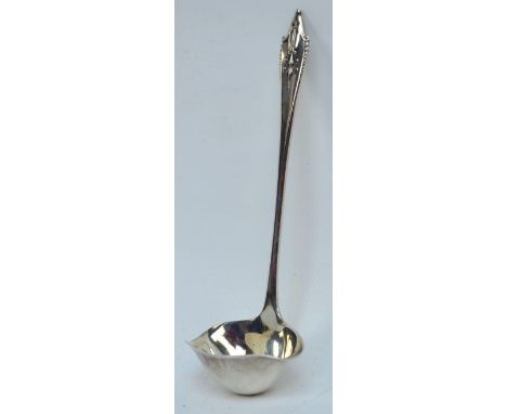GEORG JENSEN; a small hallmarked silver double lipped sauce ladle in the "Akkeleje" pattern, Jensen mark for 1915-1927, impor