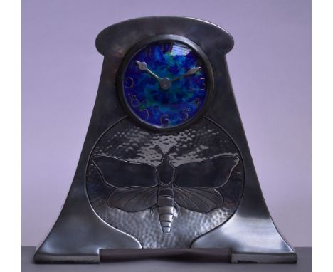 CASTLE PEWTER; a large mantel timepiece with blue/green enamel dial set with Arabic numerals above a hammered panel centred w