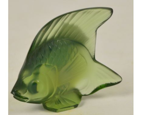 LALIQUE; a small pale green tinted model of a fish, etched mark "R. Lalique France" to side of base, height 4.75cm. CONDITION