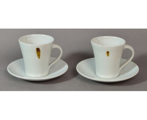 EDWARD HUGHES (1953-2006); a pair of porcelain cups and saucers covered in white glaze with iron spots, impressed EH marks, h