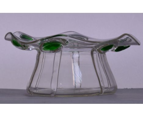 STUART; an applied peacock trail decorated bowl with shaped rim set with six green and clear glass motifs to a slightly outsw