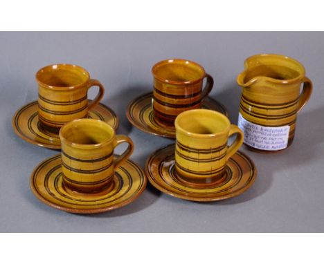 DIETER KUNZEMANN (1928-2010); four slipware cups and saucers and a matching jug, impressed DK marks, jug height 11.5cm (5). (