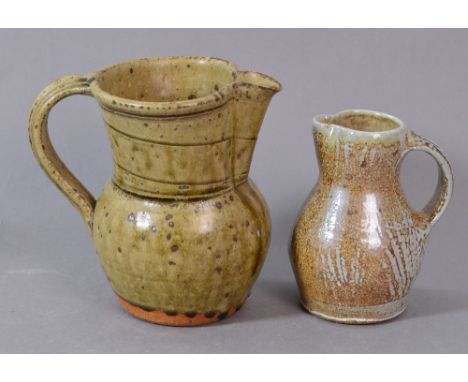 PHIL ROGERS (born 1951); a stoneware jug covered in green ash glaze, and a smaller salt glazed jug, impressed PR marks, talle