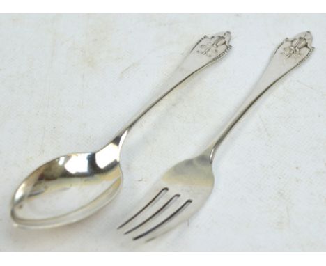 GEORG JENSEN; a hallmarked silver christening spoon and fork in the "Akkeleje" pattern, Jensen mark for 1915-1927, import mar