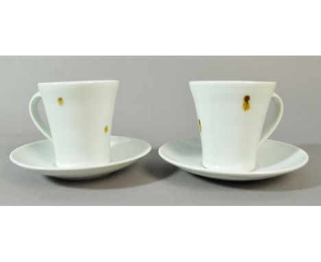 EDWARD HUGHES (1953-2006); a pair of porcelain cups and saucers covered in white glaze with iron spots, impressed EH marks, h