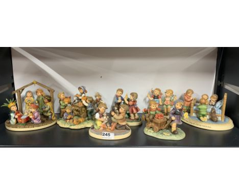 A group of seven Hummel resin group figures.