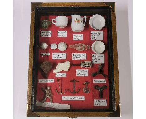 A case of mixed ceramic and metal items, 25 x 33cm. Prov. the Bruce Wale collection.