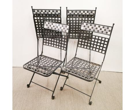 A set of four metal and tile backed folding garden chairs.