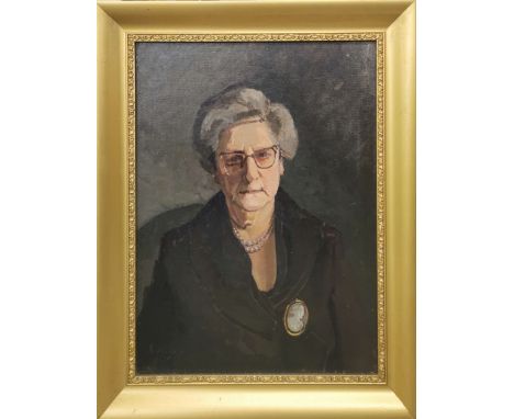 A gilt framed oil on canvas mounted on board portrait of a lady wearing a cameo brooch, frame size 43 x 54cm.
