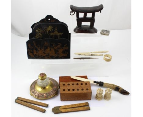 A mixed lot to include brass and copper inkwell, black lacquer letter rack and five coasters, African head rests, a pair of b