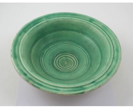 A green Art Deco style ceramic bowl, impressed mark to base, 'H.O Made in England'.
