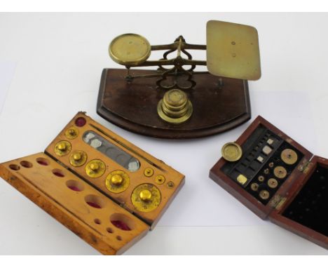 Two sets of cased jewellers' scales, smaller marked 'Gertling London' to the inside and a larger set of postal style scales, 