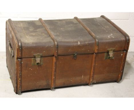 An early 20th century large brown travel trunk with leather and bamboo trim, initialled to one side 'FCH Liverpool', 100 x 48